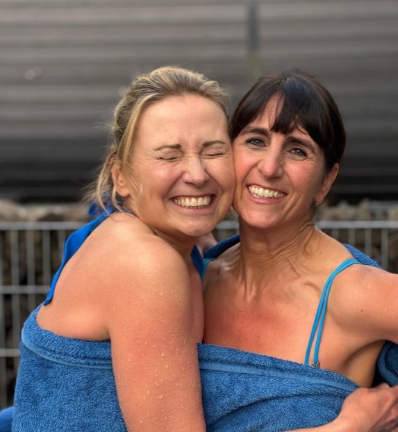 Two participants embracing and smiling after cold exposure